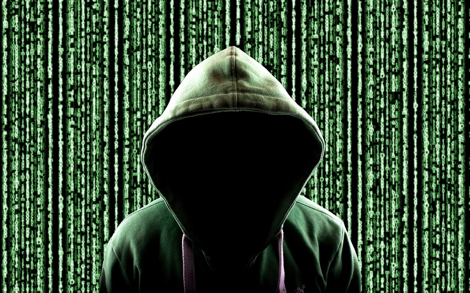 hooded person in front of code 