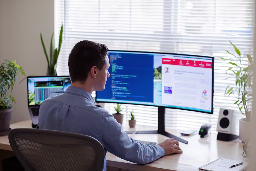 man at desk working on computer 