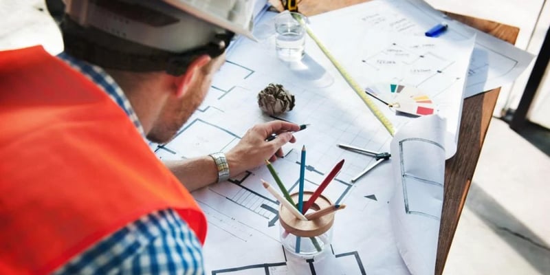 contractor looking at floor plan 