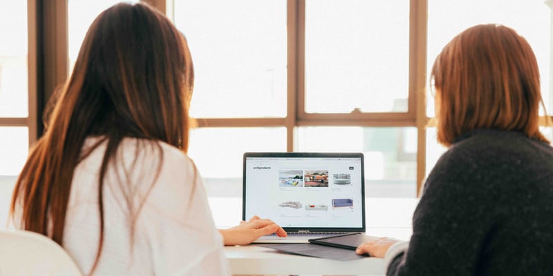 two women looking at computer 